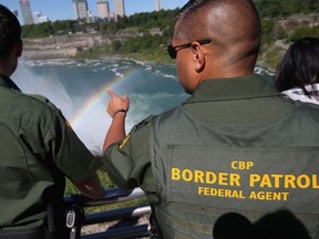 0A rainbow forms in the mist of Niagara Falls as U.S. Border Patrol agents patrol the area on June 4, 2013 in Niagara Falls, New York. The major tourist attraction, which falls directly on the U.S.-Canada border, is a major destination for international visitors. Border Patrol agents detain travelers who have overstayed their visas as well as undocumented immigrants who attempt to illegally cross the international bridge in Niagara Falls.