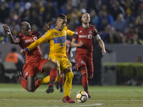 TFC's Chris Mavinga fights for the ball with Tigres' Ismael Sosa during their CONCACAF Champions League matchup earlier this year. (GETTY IMAGES)