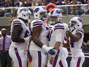 Buffalo Bills ' Josh Allen (second from right) celebrates a touchdown against Minnesota on Sunday. (GETTY IMAGES)