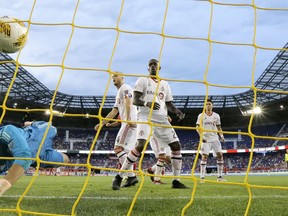 Toronto FC goalkeeper Alex Bono dives but is unable to stop a shot by New York Red Bulls midfielder Alejandro Romero Gamarra on Saturday. (AP PHOTO)