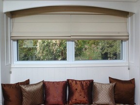 Roman blinds made from synthetic fabric from The Blind and Drapery Company used in an enclosed window seat.