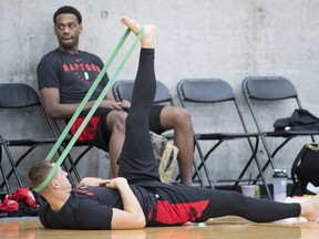 Raptors' Kyle Collinsworth uses a band to stretch following practice on Thursday. (THE CANADIAN PRESS)
