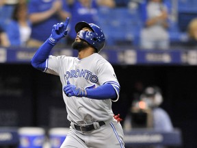 Blue Jays designated hitter Teoscar Hernandez celebrates as he reaches home plate after hitting a solo home run against the Tampa Bay Rays on Friday night. (AP PHOTO)