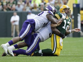 Green Bay Packers' Aaron Rodgers is hit after throwing against the Minnesota Vikings Sunday, Sept. 16, 2018, in Green Bay, Wis. (AP Photo/Mike Roemer)
