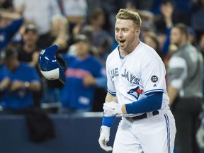 Toronto Blue Jays designated hitter Justin Smoak (14) reacts after hitting the game winning walk off home run to debated the Tampa Bay Rays during ninth inning AL baseball action in Toronto on Thursday, September 20, 2018.