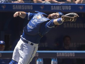 Toronto Blue Jays catcher Russell Martin bobbles but makes catch on foul ball off the bat of New York Yankees Didi Gregorius in the second inning of their American League MLB baseball game in Toronto on Sunday, July 8, 2018. THE CANADIAN PRESS/Fred Thornhill