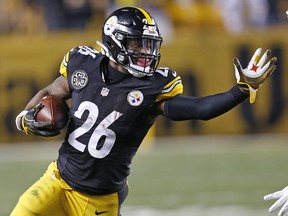 Pittsburgh Steelers running back Le'Veon Bell (26) stiff-arms Green Bay Packers strong safety Morgan Burnett (42) in Pittsburgh, Sunday, Nov. 26, 2017. (AP Photo/Keith Srakocic)