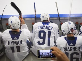 Maple Leafs linemates (from left) Zach Hyman, John Tavares and Mitch Marner are photographed by a fan between shifts during a scrimmage game at the opening day of Leafs training camp in Niagara Falls, Ont., Friday, Sept. 14, 2018. (THE CANADIAN PRESS)