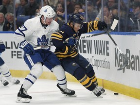 Maple Leafs hopeful Adam Brooks (left) battles with and Buffalo Sabres' Kyle Criscuolo during pre-season action. (Adrian Kraus/The Associated Press)