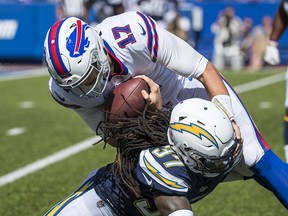 Josh Allen of the Buffalo Bills is brought down after a run by Jahleel Addae of the Los Angeles Chargers at New Era Field on September 16, 2018 in Orchard Park, New York. (Photo by Brett Carlsen/Getty Images)
