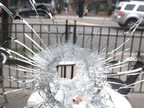 Danforth Shooting: Bullet hole in the window of the Second Cup on Danforth Ave on Monday July 23, 2018. (Craig Robertson/Toronto Sun/Postmedia Network)