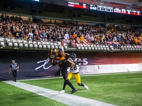 Lions’ Bryan Burnham keeps his foot in-bounds to score the tying two-point conversion with no time left in regulation on Saturday night in Vancouver against the Ticats. The Lions went on to win 35-32 in double overtime.  (THE CANADIAN PRESS)