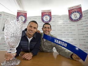 Three-time Olympic sprint medalist Andre De Grasse of Canada (left0 and jockey Ademar Santos pose for a photo as the Ricoh Woodbine Mile post-position draw on Wednesday at Woodbine Racetrack. (MICHAEL BURNS PHOTO)