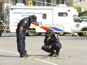 Toronto Police forensic officers at the spot where a man in his 20s was - became homicide 71 of the year - gunned down in a targeted shooting on Warden Ave. north of Danforth Rd., on Friday August 31, 2018. (Jack Boland/Toronto Sun/Postmedia Network)