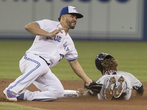 Cleveland Indians' Jose Ramirez is out trying to steal second base as Toronto Blue Jays' Devon Travis applies the tag in the fourth inning of their American League MLB baseball game in Toronto on Sept.  6, 2018. Blue Jays catcher Reese McGuire, making his major-league debut, threw Ramirez out.
(FRED THORNHILL/The Canadian Press)