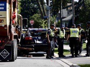 Police investigate after a man was crushed between a garbage truck and a car in Etobicoke on Wednesday, Sept. 5 2018. Ernest Doroszuk/Toronto Sun