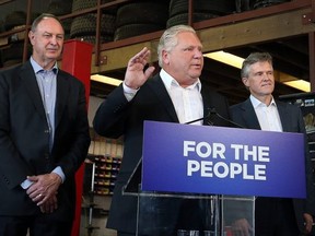 Premier Doug Ford, is joined by Rod Phillips, Minister of the Environment, right, and John Yakabuski, Minister of Transportation, left, to announce the cancellation of the Drive Clean program in Ontario on Friday, September 28, 2018. Dave Abel/Toronto Sun
