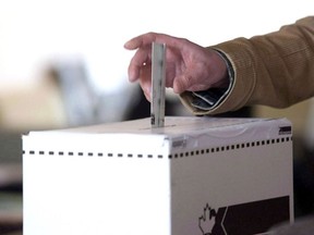 A voter casts a ballot in the election in Toronto on May 2, 2011.