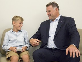 Eric Lindros jokes with 11-year-old Sheldon Geerts prior to a press conference in London, Ont. on Thursday August 16, 2018. (Derek Ruttan/The London Free Press/Postmedia Network)