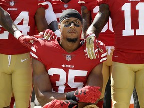 In this Sept. 10, 2017, file photo, San Francisco 49ers safety Eric Reid (35) kneels in front of teammates during the playing of the national anthem before a game against the Carolina Panthers in Santa Clara, Calif. (AP Photo/Marcio Jose Sanchez, File)