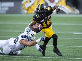 Hamilton Tiger-Cats wide receiver Brandon Banks (16) runs away from Toronto Argonauts Declan Cross (38) during first half CFL Football game action in Hamilton, Ont. on Monday, September 3, 2018. THE CANADIAN PRESS/Peter Power