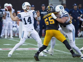 Argonauts quarterback McLeod Bethel-Thompson (left) makes a throw against the Tiger-Cats on Monday.  Peter Power/The Canadian Press