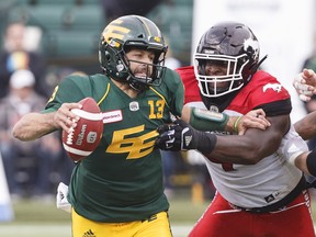 Calgary Stampeders’ Micah Johnson (right) grabs Eskimos quarterback Mike Reilly during their game last weekend. Reilly took a hit up high during the game, but says it is happening less and less every year.  The Canadian press