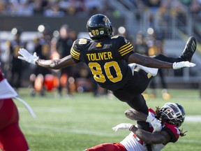 Stampeders defensive back Troy Stoudermire takes down Tiger-Cats wide receiver Terrence Toliver on Saturday.  CP