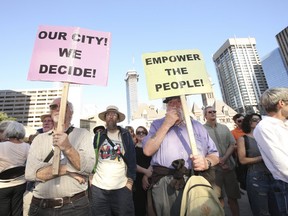 Protestors gather outside Toronto city hall Wednesday evening expressing their dismay over Premier Doug Ford's plan to reduce the number of council seats. (Jack Boland/Toronto Sun)