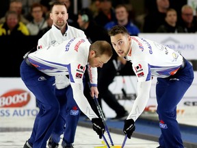 Second Brett Gallant, right, and lead Geoff Walker sweep for skip Brad Gushue of St. John's during the men's final in the Grand Slam of Curling's Princess Auto Elite 10 tournament at Thames Campus Arena in Chatham, Ont., on Sept. 30, 2018. (MARK MALONE/Postmedia Network)