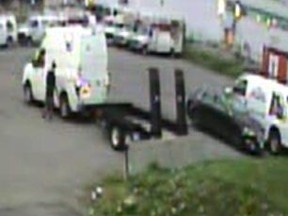 A man can be seen with the white Nissan NV cargo van with no plates and a stolen runaway utility trailer in Brampton on Aug. 1, 2018. (Peel Regional Police handout)