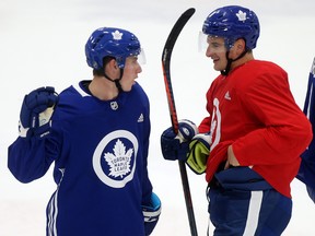 Leafs forward Mitch Marner left) talks to Zach Hyman during practice at MasterCard Centre. DAVE ABEL/TORONTO SUN