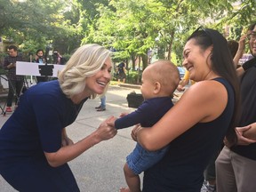 Mayoral candidate Jennifer Keesmaat greets a baby as she speaks about her transit plan for Toronto on Friday, Sept. 7, 2018. (Antonella Artuso/Toronto Sun)