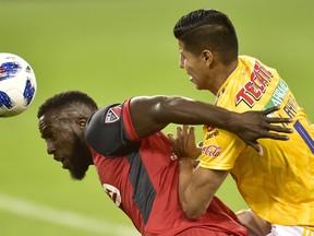 Toronto FC forward Jozy Altidore (left) battles with Tigres defender Hugo Ayala during Wedenesday’s Campeones Cup action in Toronto. Altidore and Lucas Hanson are the expected pair up front against New York on Saturday. (FRANK GUNN/THE CANADIAN PRESS)
