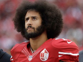 In this Dec. 11, 2016, file photo, San Francisco 49ers quarterback Colin Kaepernick stands in the bench area during the second half of the team's NFL football game against the New York Jets in Santa Clara, Calif.