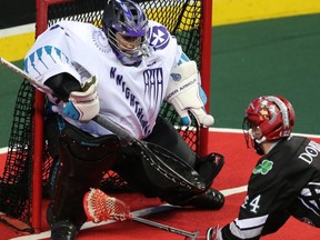 Roughnecks' Dane Dobbie fires a shot on Knighthawks goaltender Angus Goodleaf during NLL action in Calgary on March 17, 2018.