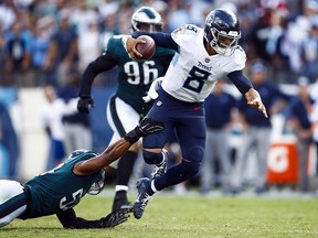 Marcus Mariota of the Tennessee Titans gets away from Jordan Hicks of the Philadelphia Eagles during overtime at Nissan Stadium on September 30, 2018 in Nashville. (Wesley Hitt/Getty Images)