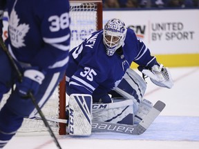 Maple Leafs Curtis McElhinney keeps and eye on the action during Friday's pre-season game against the Buffalo Sabres. (Jack Boland/Toronto Sun)