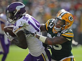 Minnesota Vikings receiver Stefon Diggs catches a pass over the Packers’ Jaire Alexander of the Green Bay Packers at Lambeau Field in Green Bay, Wisc. yesterday. The game ended in a 21-21 tie. Getty images