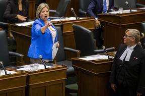 Ontario NDP leader Andrea Horwath is escorted out of the legislature by the Sgt-at-Arms on Wednesday. (Ernest Doroszuk/Toronto Sun)