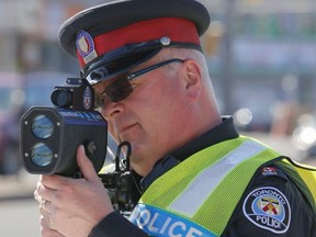 Toronto Police Const. Dave Burnell uses radar to nab speeders on Jane St. at Weston Rd. on Sunday April 12, 2015. (Dave Thomas/Toronto Sun files)