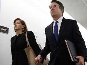 Brett Kavanaugh, President Donald Trump's Supreme Court nominee, and his wife Ashley Estes Kavanaugh, hold hands as they arrive for a Senate Judiciary Committee hearing on Capitol Hill in Washington, Thursday, Sept. 27, 2018.