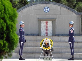Taiwan's honour soldiers stand in front of an monument to the cemetery of the National Revolutionary Army during the 60th anniversary of the '823 bombardment' in Kinmen on August 23, 2018. (SAM YEH/AFP/Getty Images)