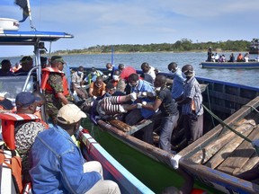 Rescuers retrieve a body from the water near Ukara Island in Lake Victoria, Tanzania, Friday, Sept. 21, 2018. (AP Photo)