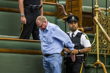 A man in the public gallery is led away in restraints by Queen's Park Special Constables during the morning session in the legislature at Queen's Park in Toronto, Ont. on Wednesday September 12, 2018. Ernest Doroszuk/Toronto Sun/Postmedia