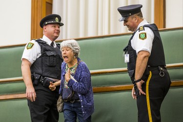 A woman is removed from the public gallery by Queen's Park Special Constables during the morning session in the legislature at Queen's Park in Toronto, Ont. on Wednesday September 12, 2018. Ernest Doroszuk/Toronto Sun/Postmedia