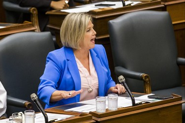 Ontario NDP leader Andrea Horwath, along with most of her MPPs, pound their desks in protest during the afternoon session in the legislature at Queen's Park in Toronto, Ont. on Wednesday September 12, 2018. Ernest Doroszuk/Toronto Sun/Postmedia