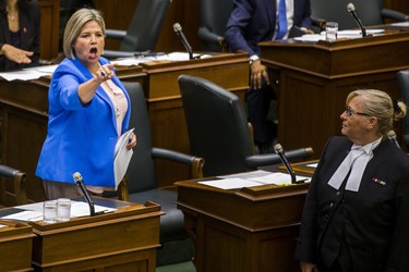 Ontario NDP leader Andrea Horwath is escorted out of the legislature by the Sgt-at-Arms during while she along with most of her MPPs were pounding their desks in protest during the afternoon session in the legislature at Queen's Park in Toronto, Ont. on Wednesday September 12, 2018. Ernest Doroszuk/Toronto Sun/Postmedia