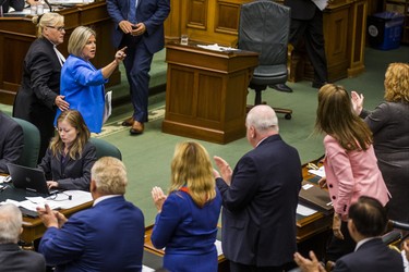 Ontario NDP leader Andrea Horwath gestures at PC MPPs as she is escorted out of the legislature by the Sgt-at-Arms during while she along with most of her MPPs were pounding their desks in protest during the afternoon session in the legislature at Queen's Park in Toronto, Ont. on Wednesday September 12, 2018. Ernest Doroszuk/Toronto Sun/Postmedia