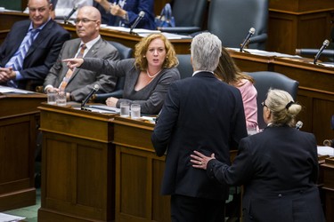 Ontario PC Lisa MacLeod, Minister of Children, Community and Social Services, gestures at an Ontario NDP MPP who is being escorted of out of the legislature
by the Sgt-at-Arms during a protest of pounding their desks during the afternoon session in the legislature at Queen's Park in Toronto, Ont. on Wednesday September 12, 2018. Ernest Doroszuk/Toronto Sun/Postmedia